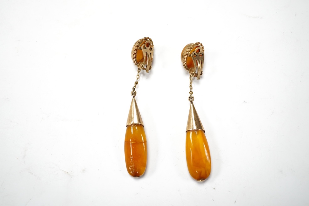 A pair of yellow metal and two stone amber set drop ear clips, 68mm, gross weight 8 grams. Condition - poor